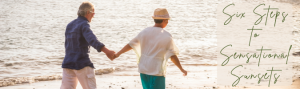 Older couple running barefoot on a sunset beach.