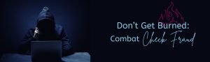 Scammer in a hoodie on a computer in the dark.
