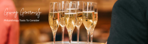 Champagne flutes carried on a platter at a gala.